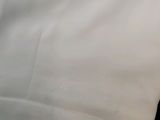 someone holding a cell phone up to their ear while laying on a bed
