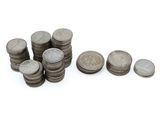a pile of coins sitting next to each other on a white surface
