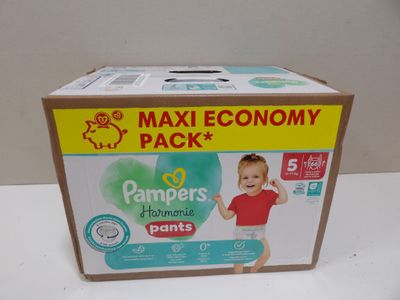 a box of diapers on a table with a baby in it