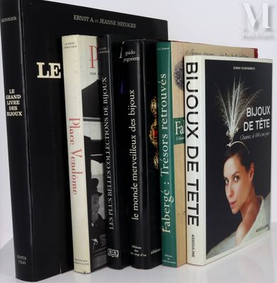 several books are lined up on a white table