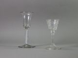 two wine glasses sitting next to each other on a table