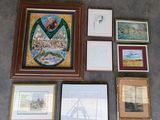 many framed and unframed art pieces on the floor