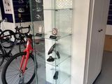 a glass display case in the middle of a room with bicycles