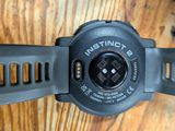 a close up of a watch on a wooden table