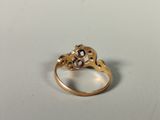 a close up of a gold ring with a flower design on it