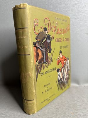 an old book sitting on top of a table next to a white wall