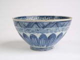 a blue and white bowl sitting on a white surface