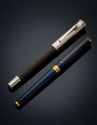 a pen and a ballpoint pen on a black background