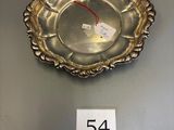a silver plate with a number on it sitting on a table