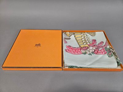 an orange box containing a handkerchief with a picture of a dragon on it