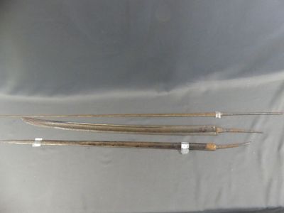 three wooden arrows are sitting on a table with a white cloth