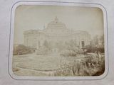 an old photo of a building in the middle of a field