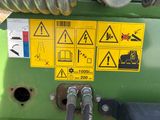 a yellow sign on the side of a green machine
