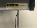 a metal table with a sign on it that says cometal
