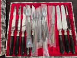 a box with a bunch of knives and knives in it