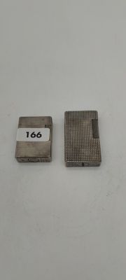 a close up of two lighters on a white surface