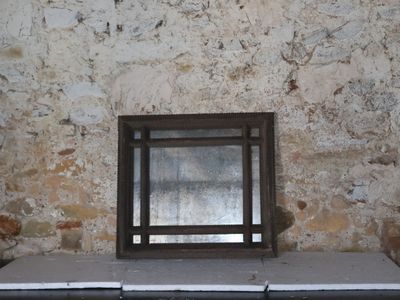 a window in the middle of a stone wall