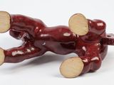 a figurine of a dog laying on its back