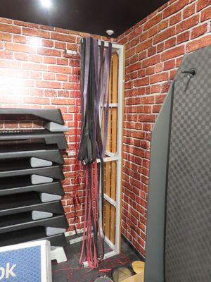 brick wall in a gym room with a rack of exercise equipment
