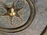 a large metal plate with a flower design on it