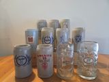 a lot of beer cans and glasses on a table