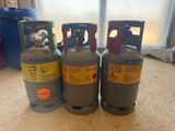 three propane gas bottles sitting on top of a counter