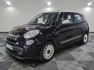 the small black car is parked on a checkered tile floor