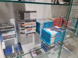 a lot of dvds on display in a glass case