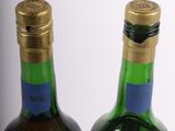 two bottles of wine sitting next to each other on top of a table