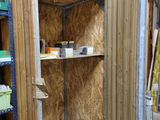 a small room with a shelf and shelves in it