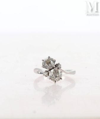 a close up of a diamond ring on a white surface