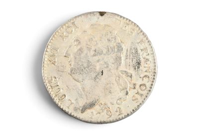 an old silver coin on a white surface with a white background