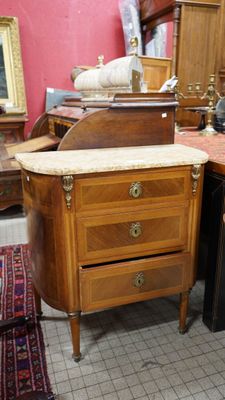 a lot of antique furniture on display in a room