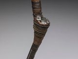 a bronze statue of a bird with a long neck on a stand