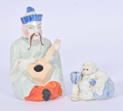 a figurine of a man playing a guitar next to a sheep