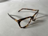 a pair of glasses sitting on a white surface