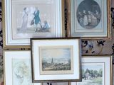 many framed pictures of people and animals on the wall