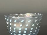 a white and blue bowl with polka dots on it