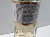 a close up of a bottle of perfume on a table