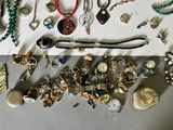 many different types of jewelry on the table
