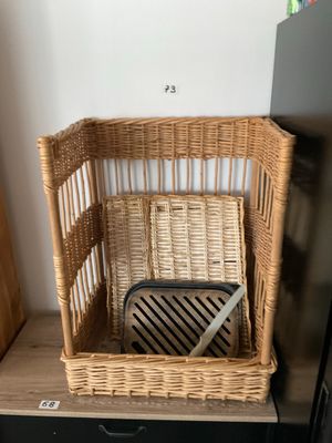 a wicker basket that is on top of a shelf