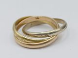 three gold and silver rings on a white surface
