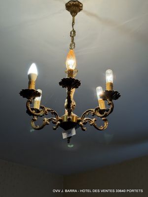 a chandelier with three lights hanging from it ' s ceiling
