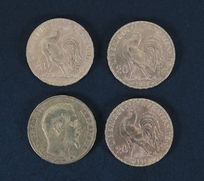four different british coins sitting on top of a blue surface