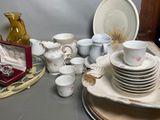 a lot of dishes and cups on the table