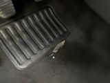 a close up of a car ' s floor mat and a car ' s wheel