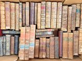 a box full of old books sitting on the floor