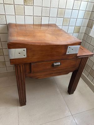 a wooden table with a drawer on it in a bathroom