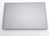 dell laptop computer sitting on a white surface with a dell logo on the screen
