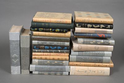 several books stacked on top of each other on a gray surface